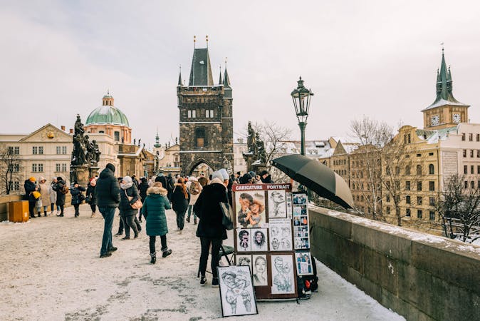 People walking on Charles Bridge in Prague during winter