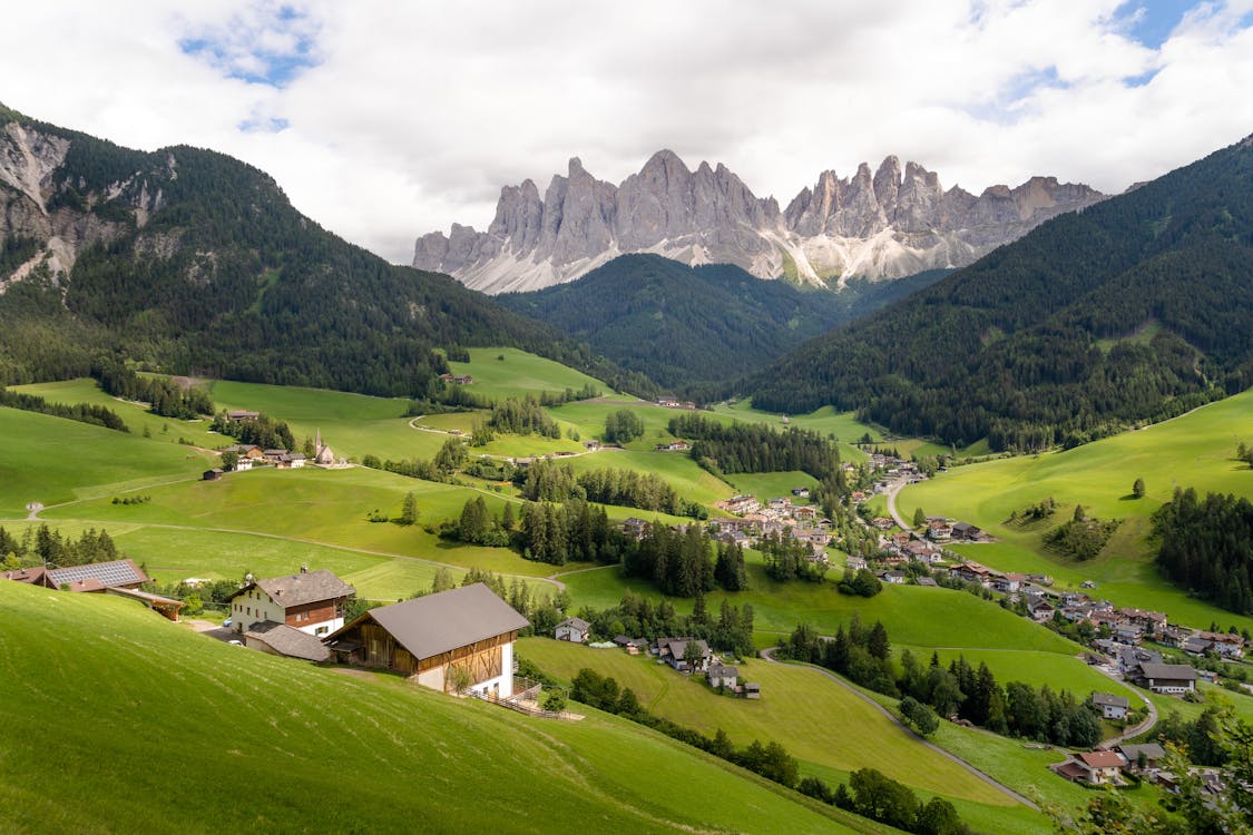 Scenic view of Santa Maddalena village in Val di Funes with the jagged Odle peaks of the Dolomites in the background