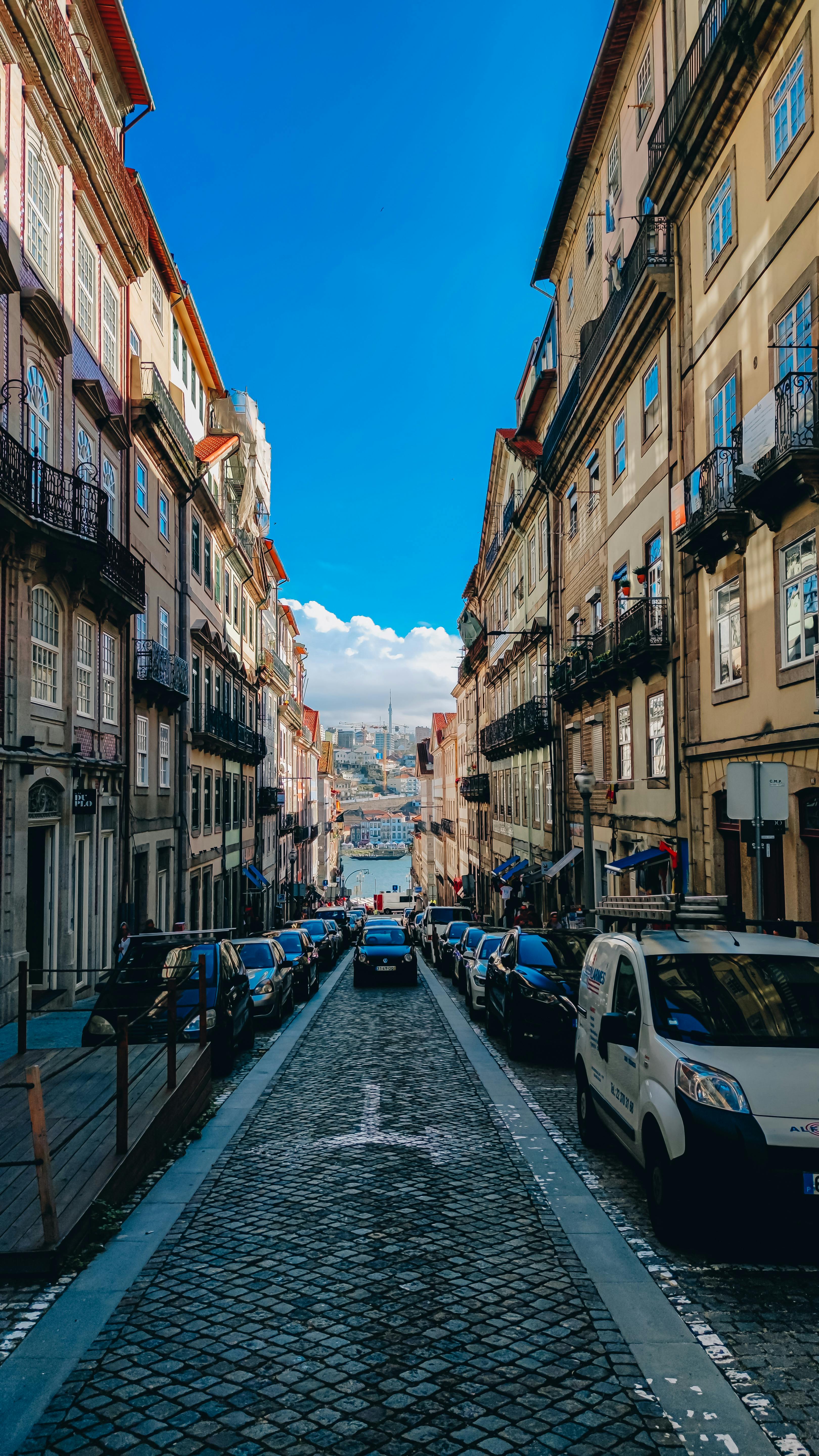 Narrow atmospheric street in Porto, Portugal with colorful facades and cobblestone alley